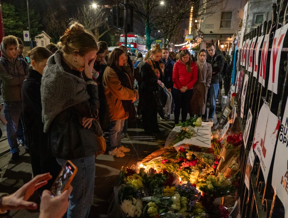 People gather outside the Russian embassy in London