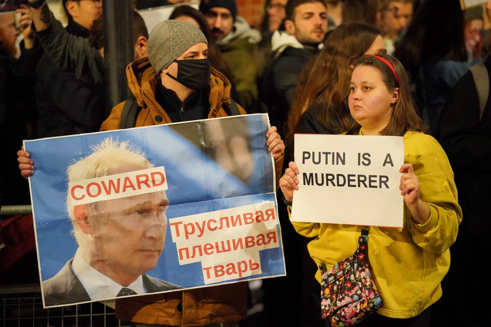 People take part in a protest opposite the Russian Embassy in London