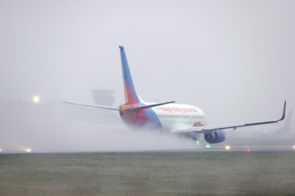 Planes battle adverse weather conditions on the runway at Leeds Bradford airport today