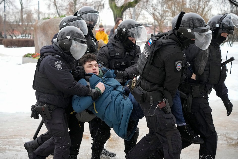 A man being carried away in St. Petersburg, Russia after attending a service