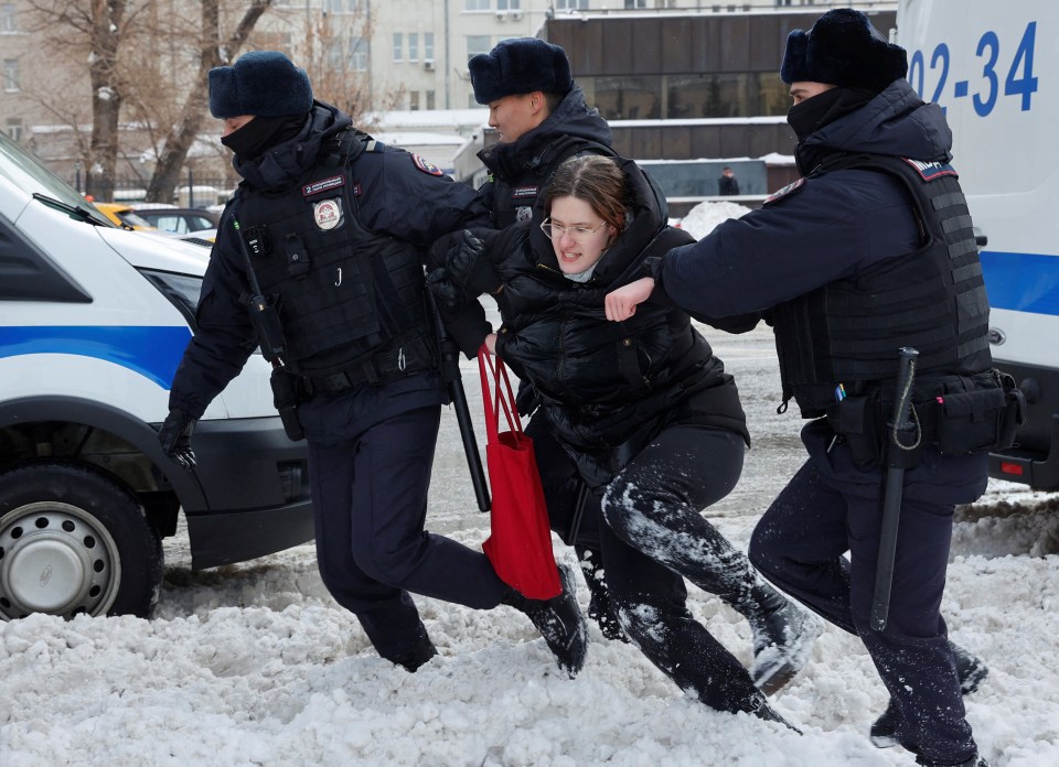 A woman battling against cops as they take her away from the protests in Moscow