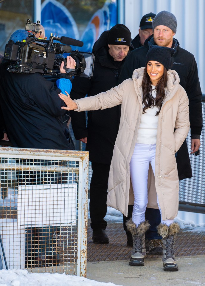 Meghan was seen gently patting the arm of a cameraman as they arrived