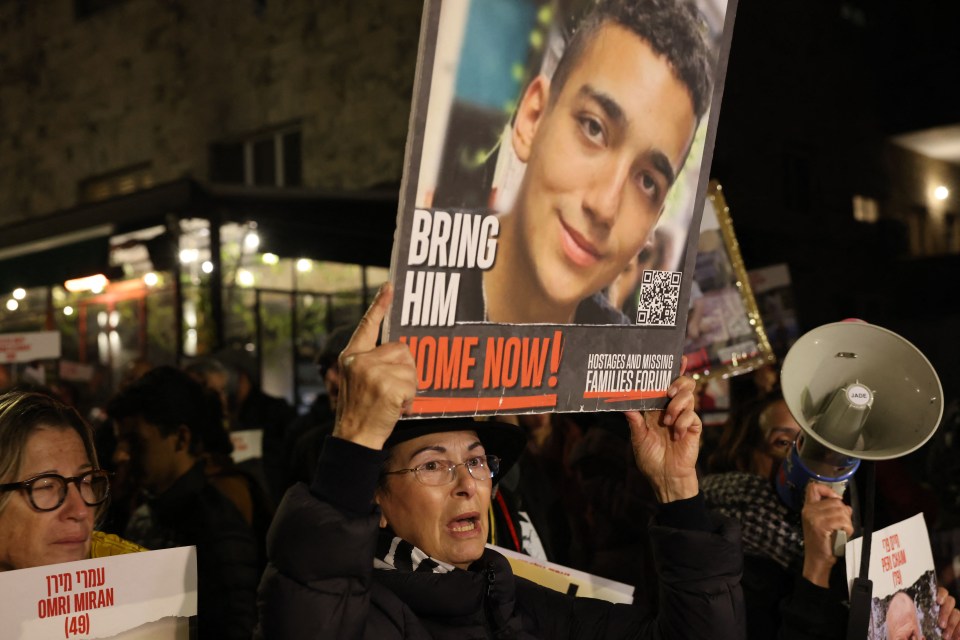 Protesters hold up portraits during a rally by family and supporters of Israeli hostages held in Gaza since October 7