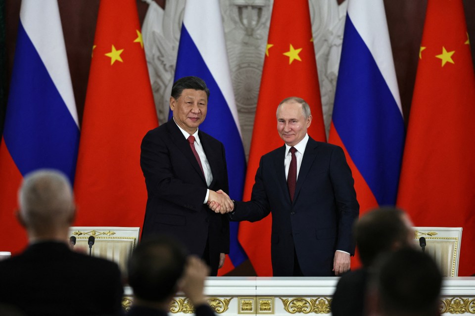 Russian President Vladimir Putin shaking hands with China's Xi Jinping at Kremlin