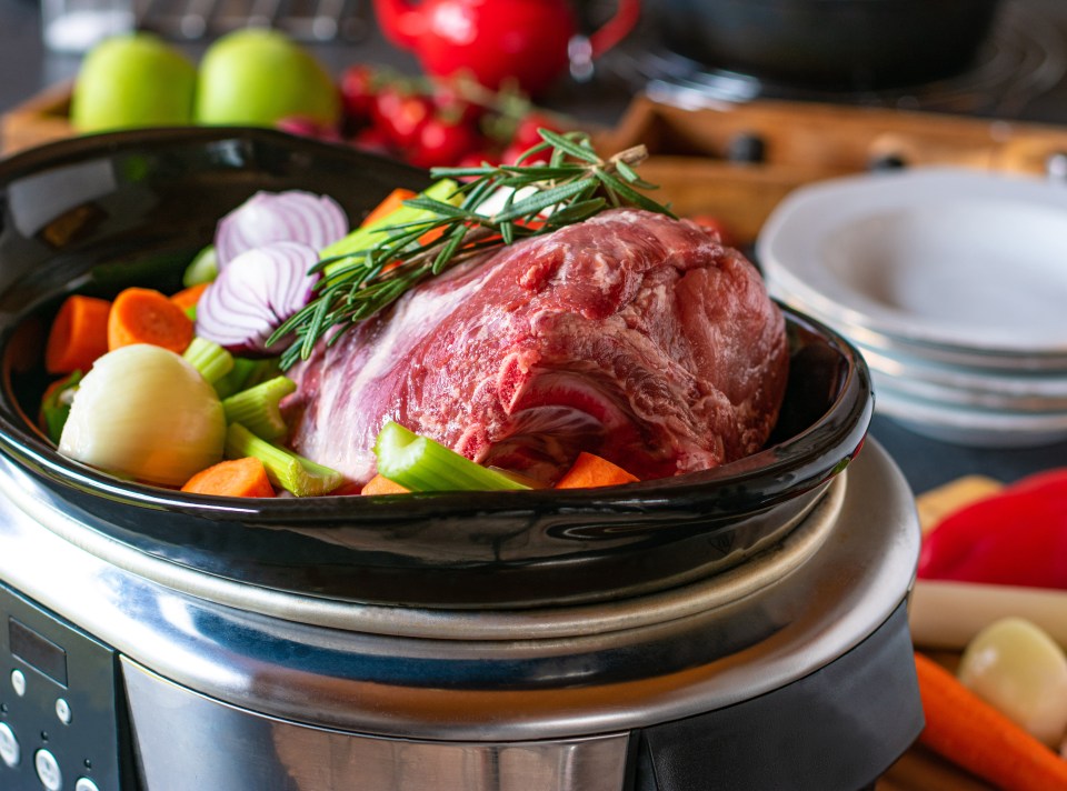 raw and uncooked Roast pork with root vegetables in a slow cooker; Shutterstock ID 1932372311; purchase_order: -; job: -; client: -; other: -