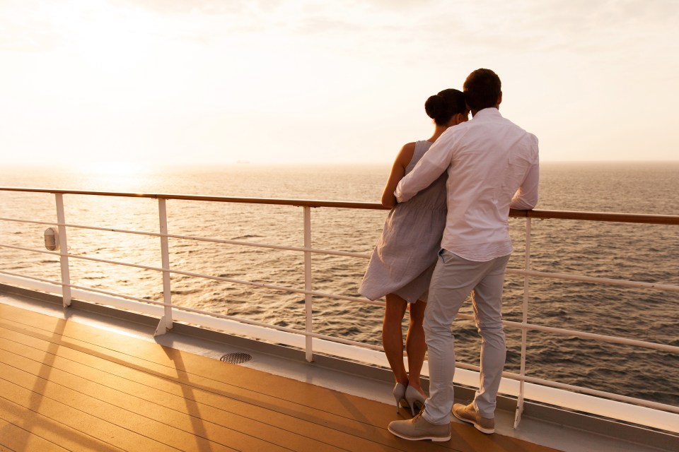 back view of young couple hugging at sunset on cruise ship; Shutterstock ID 235800790; purchase_order: -; job: -; client: -; other: -