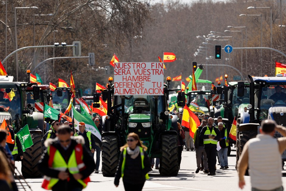 A sign on a tractor reading ‘Our end will be your hunger, defend your food’ is seen as farmers protest to denounce their conditions in Madrid, on February 26