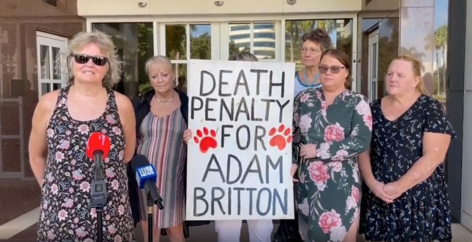 Protesters outside the court case call for Britton to be executed