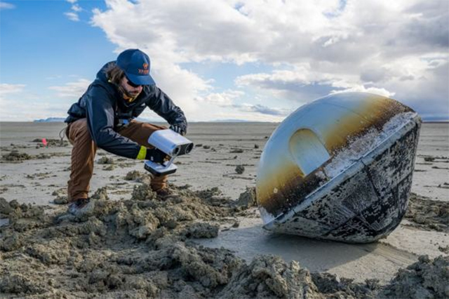 At the end of the shortened video, you'll see a pair of muddy legs retrieve the capsule and gather the parachute