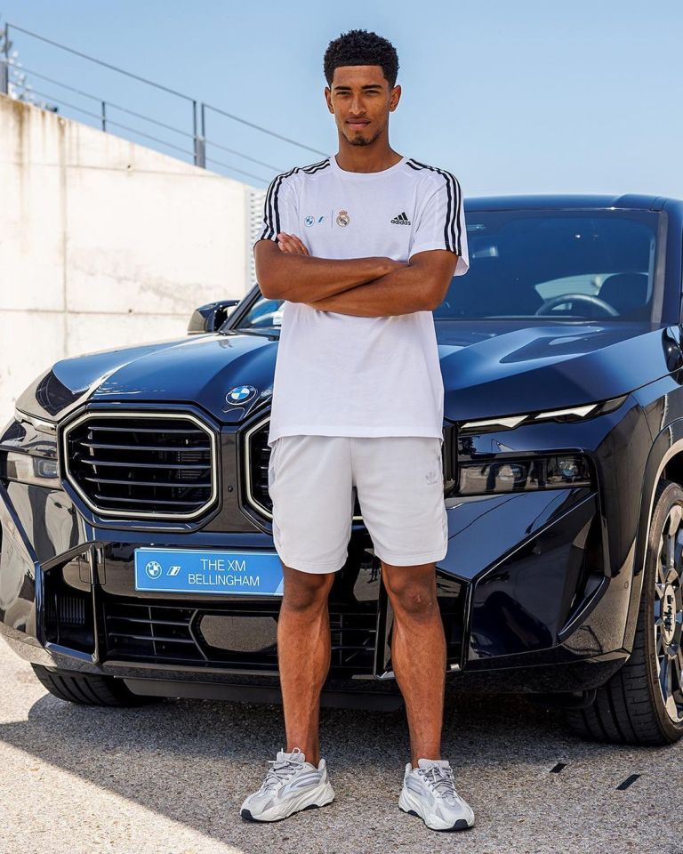 Jude Bellingham poses with his £155,000 electric BMW