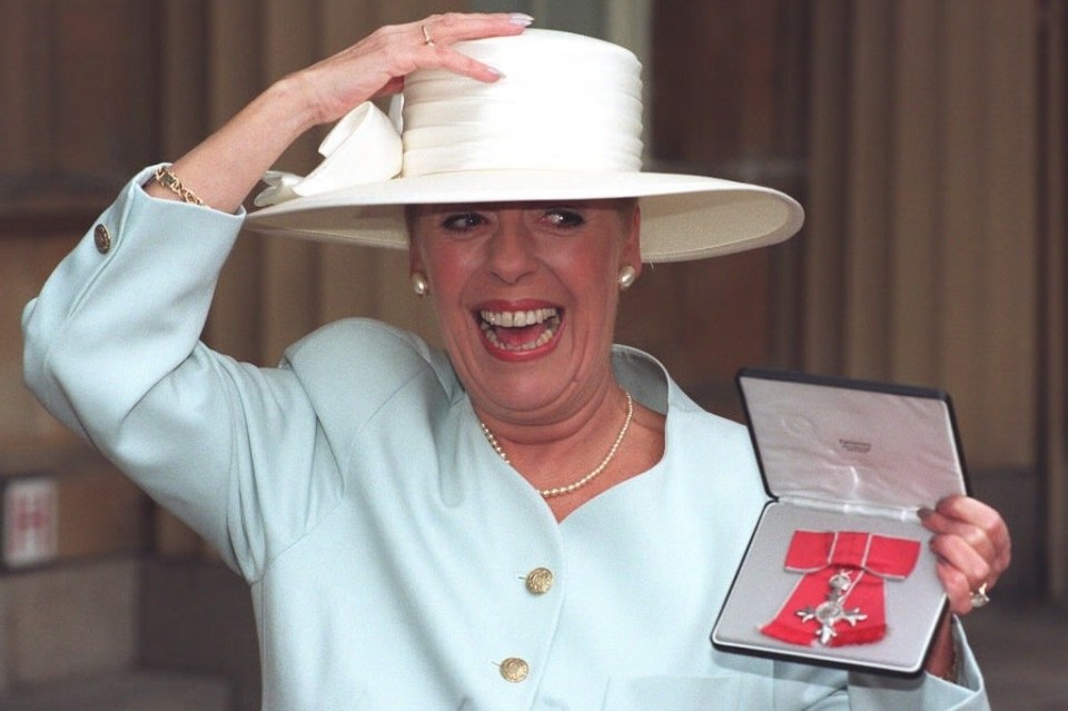 Julie was awarded an MBE for services to acting in 1996. Pictured, outside Buckingham Palace