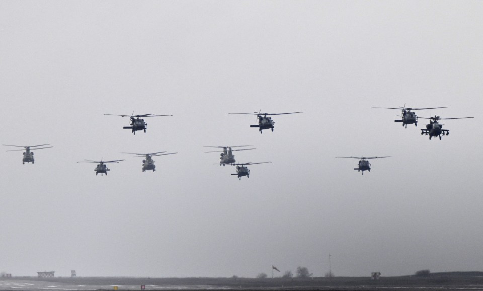 Different types of helicopters, among them Chinook, Black Hawk and Apache, fly during the final display formation as part of the rotation of US troops of the US Army 101 Airborne division