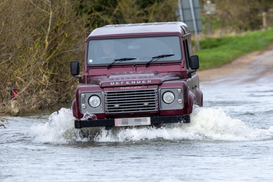 A vehicle struggles along the roads in Sutton Gault, Cambridgeshire, on Wednesday after the New Bedford River burst its banks