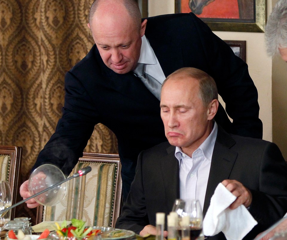 Yevgeny Prigozhin, top, serves food to then-Russian Prime Minister Vladimir Putin in Moscow in 2011