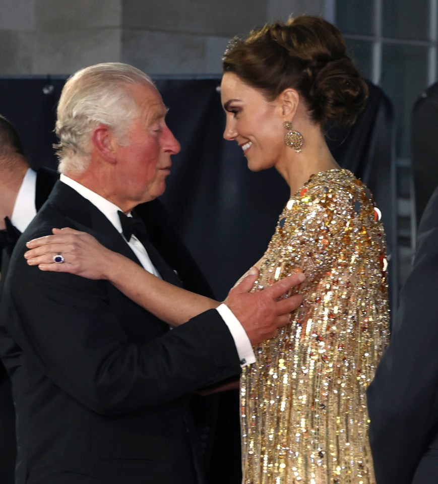 Britain’s Prince Charles, left, speaks with Kate, the Duchess of Cambridge