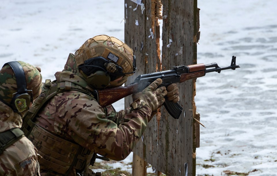 A Ukrainian troop fires a weapon at a shooting range near Kharkiv, Ukraine