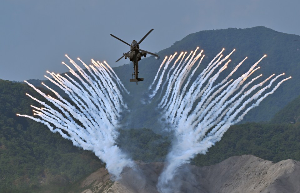 An Apache firing flares