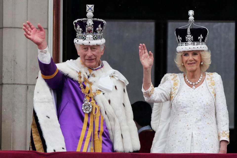 Britain’s King Charles III and Queen Camilla wave to the crowds from the balcony of Buckingham Palace after the coronation ceremony