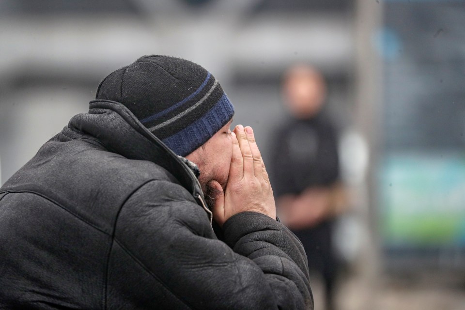 A man mourns outside the venue in Moscow