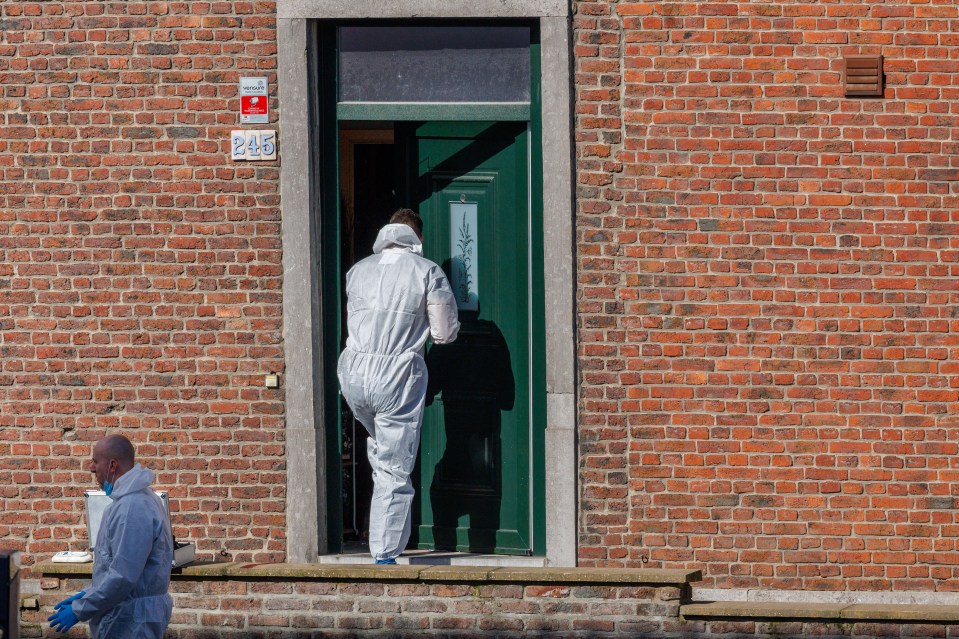 A police crime scene unit inspects the house where an officer was killed during the stand-off