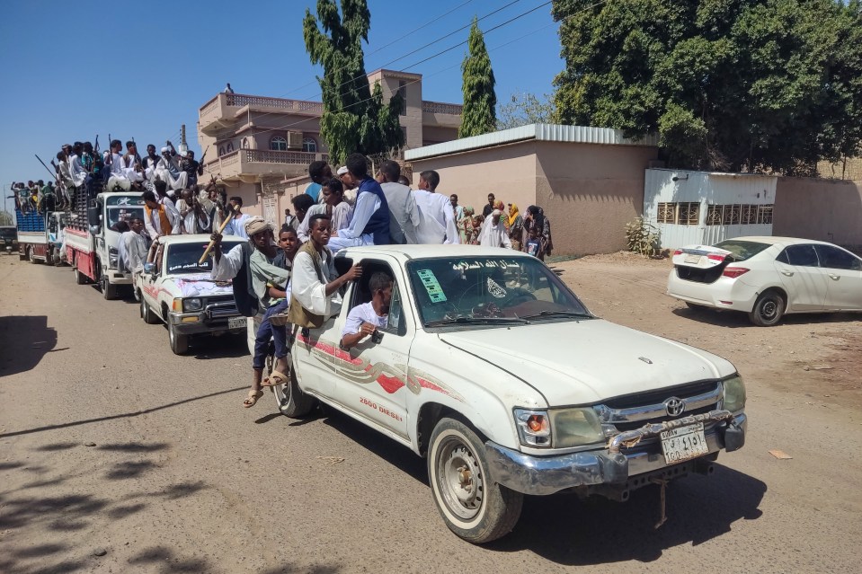 Sudanese supporters of the Sudanese armed popular resistance, which supports the army, ride on trucks in Gedaref