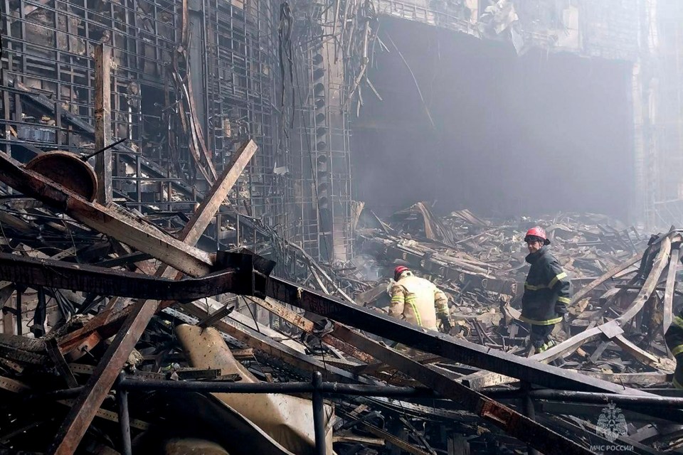 Emergency workers searching for people in the wreckage