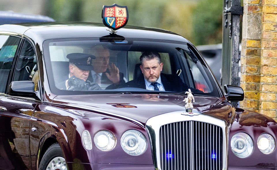 The monarch was spotted waving at royal fans from his State car