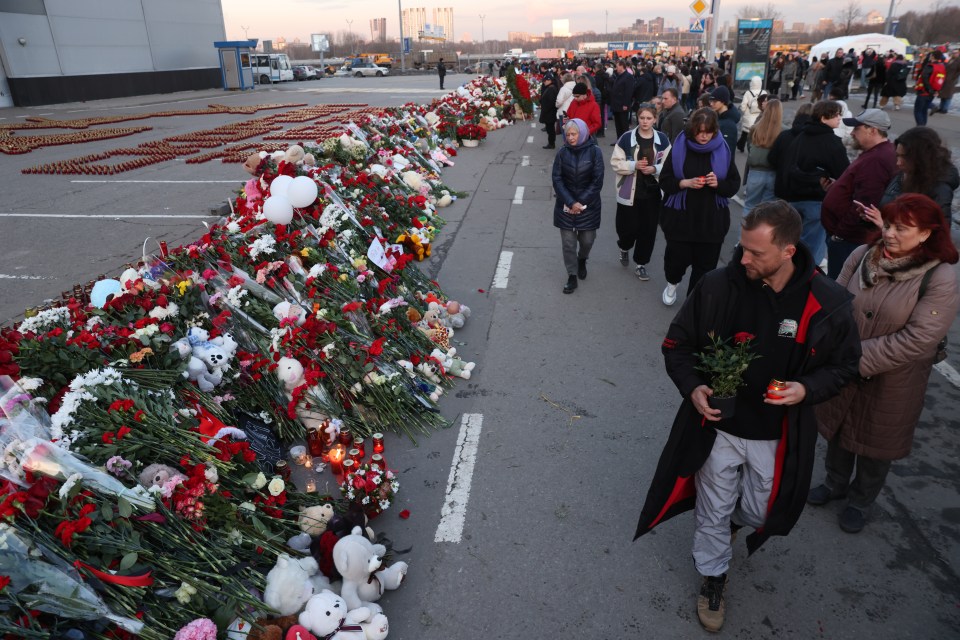 Mourners attend a growing makeshift memorial outside the concert hall on Moscow’s outskirts