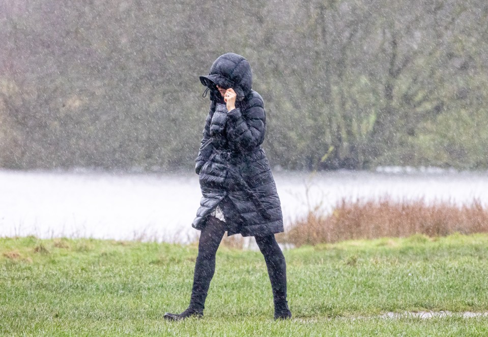 Commuters braved the wind and rain on Wimbledon Common, south-west London, this morning