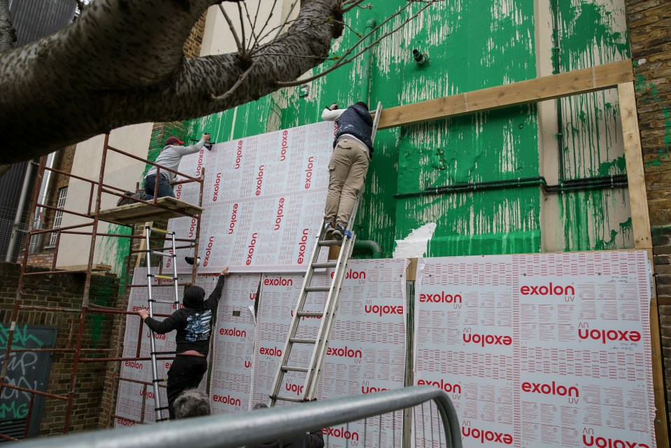 After builder George erected his perspex screen with the help of workmen, the council installed a wooden wall