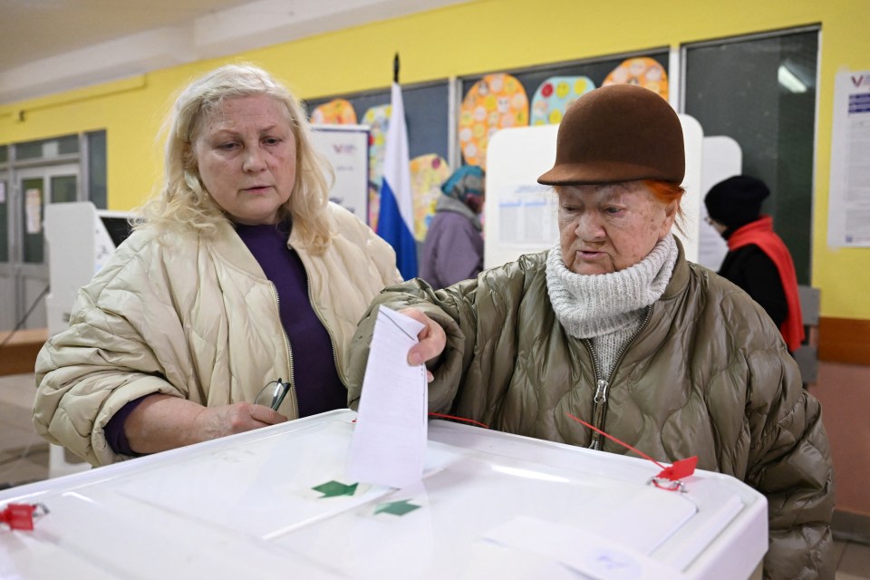 A woman casts her ballot on the last day of Russia's elections today