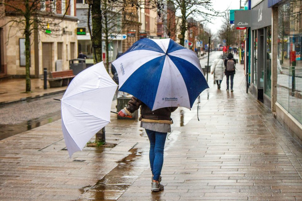 This shopper in Preston, Lancashire, wasn't taking any chances earlier in the week with two umbrellas