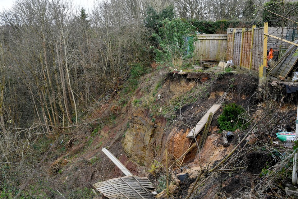 A massive landslip behind their gardens gets bigger every time it rains