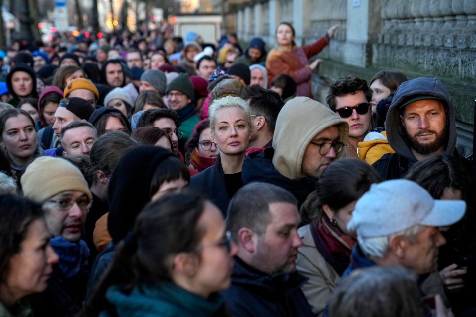 Navalny's widow Yulia Navalnaya, centre, stands in a queue with other voters at a polling station near the Russian embassy in Berlin on Sunday