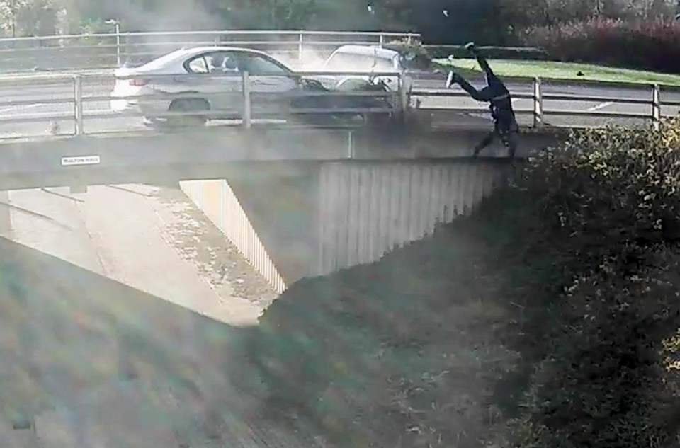 The rider was wedged between his silver BMW 320 and the metal railing of the bridge