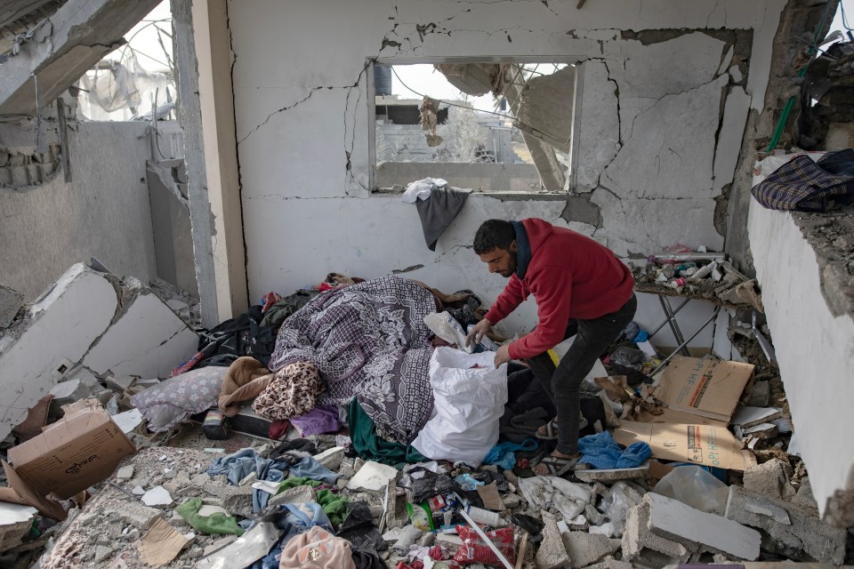 A man inspects his home after an Israeli air strike at Al-Najjar Hospital in Rafah