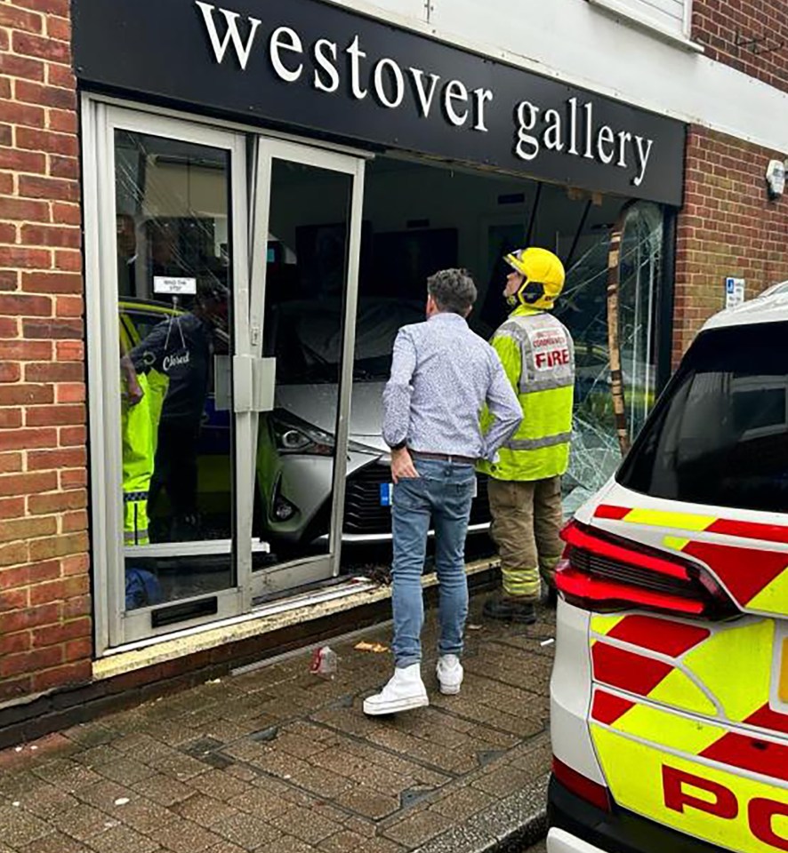 Gallery owner Calvin Smith claims to have been given a parking ticket after a car crashed into his shop