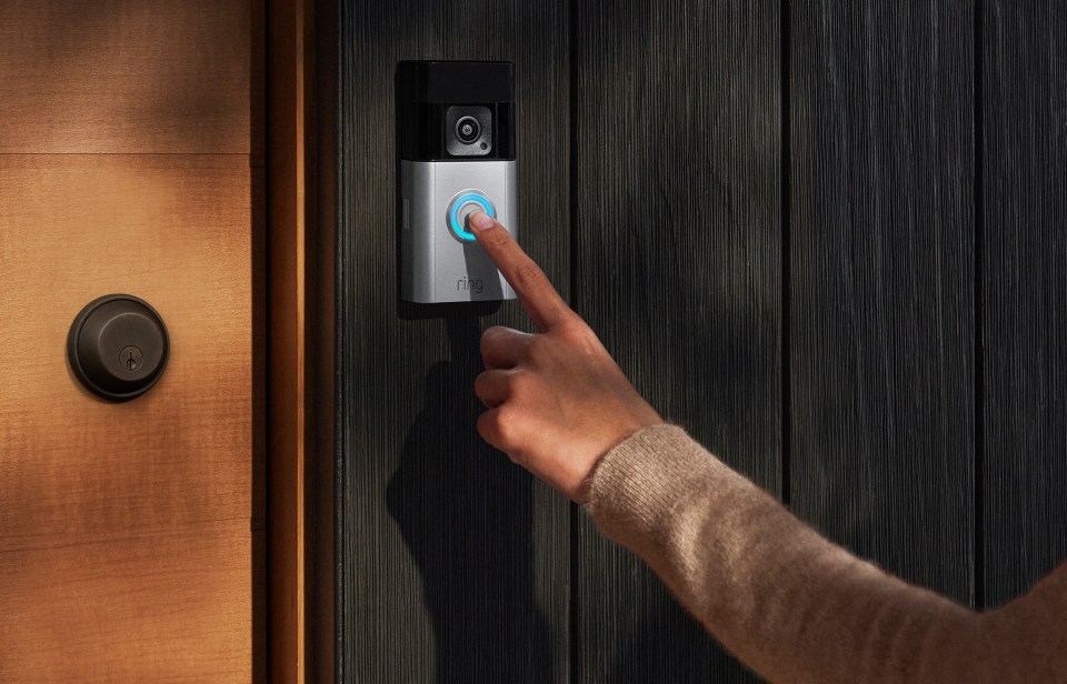 a person is pressing a button on a ring doorbell