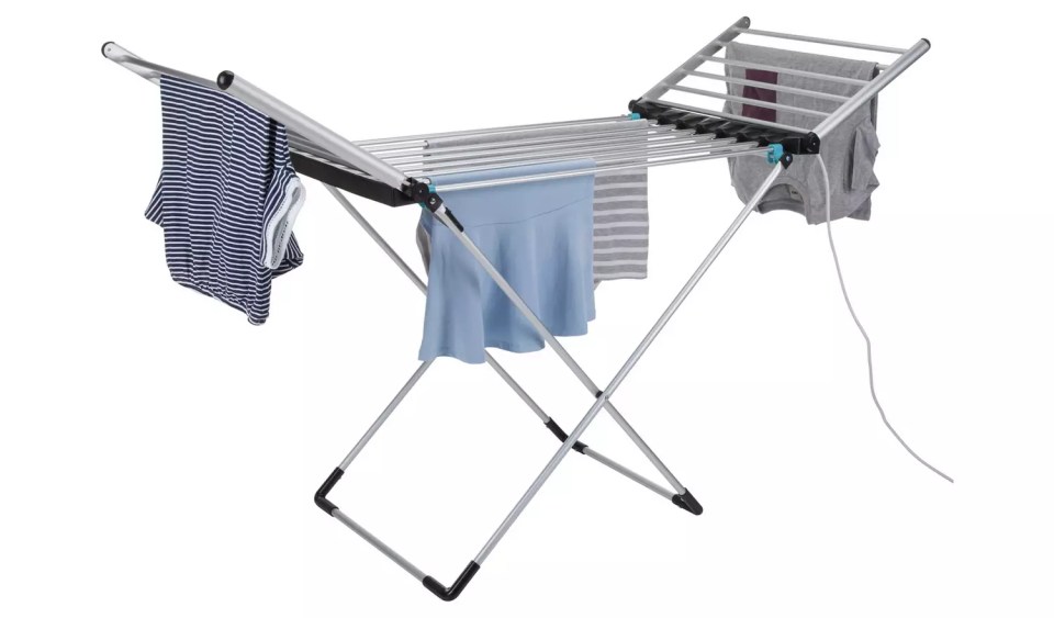 a clothes drying rack with clothes hanging on it