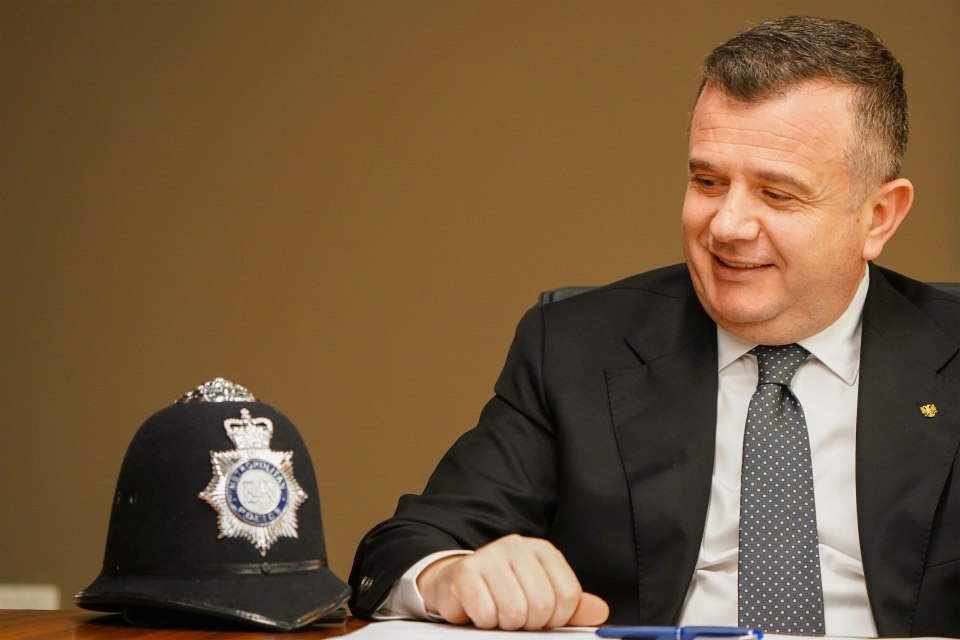 A British bobby’s helmet takes pride of place on a shelf in the grand governmental office of Albania’s Interior Minister, Taulant Balla