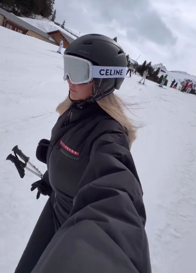 a woman wearing ski goggles and a celine helmet