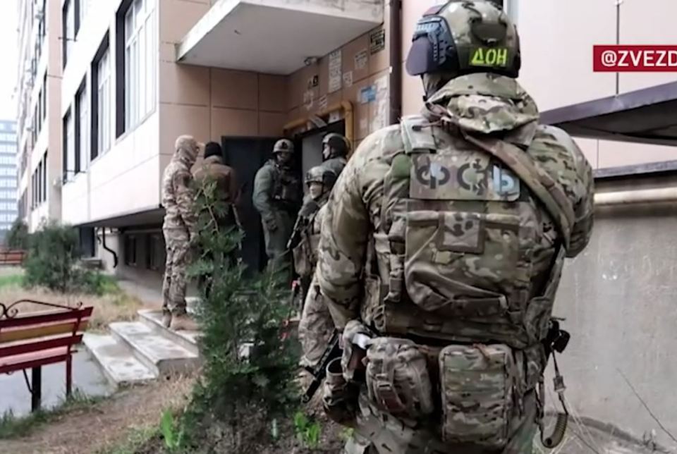 Soldiers outside the residential building after smoke was spotted coming from one of the windows