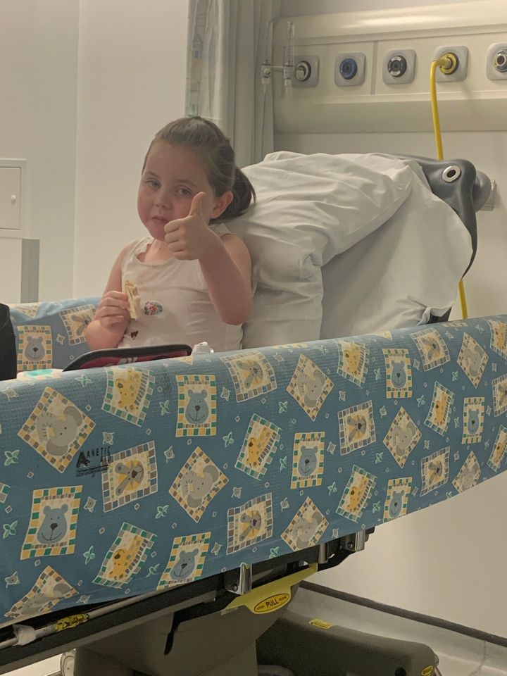 Brave Mercy gives a thumbs up during her hospital treatment