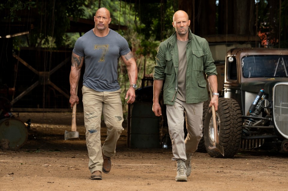 This image released by Universal Pictures shows Dwayne Johnson, left, and Jason Statham in a scene from "Fast & Furious Presents: Hobbs & Shaw." Movie going audiences have helped the Fast & Furious spinoff Hobbs & Shaw take another lap at No. 1 even with the onslaught of new movies this weekend. Universal Pictures estimates Sunday, Aug. 11, 2019 that Hobbs & Shaw added $25.4 million from North American theaters, bringing its domestic total to $108.5 million. (Frank Masi/Universal Pictures via AP)