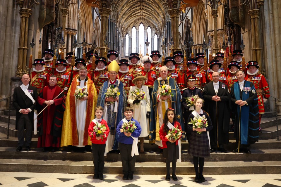 WORCESTER, ENGLAND - MARCH 28: Queen Camilla holds the Nosegay bouquets as she poses with Yeomen of the Guard and and religious representatives during The Royal Maundy Service at Worcester Cathedral On March 28, 2024 in Worcester, England. The Royal Maundy is an ancient ceremony, inspired by The Bible On the day before Good Friday, Jesus washed the feet of his disciples and commanded them to 'Love one another'. By the thirteenth century the Royal Family was taking part in similar ceremonies. Queen Camilla distributes Maundy Money to a selected group of Christians to thank them for their work within the Church. King Charles is Unable to attend due to him fighting an illness. On March 28, 2024 in Worcester, England. (Photo by Chris Jackson/Getty Images)