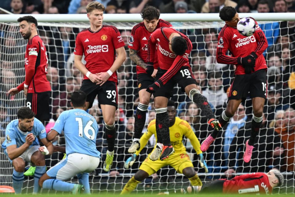 TOPSHOT - Manchester United's Brazilian midfielder #18 Casemiro (2R) blocks a freekick taken by Manchester City's Belgian midfielder #17 Kevin De Bruyne during the English Premier League football match between Manchester City and Manchester United at the Etihad Stadium in Manchester, north west England, on March 3, 2024. (Photo by Paul ELLIS / AFP) / RESTRICTED TO EDITORIAL USE. No use with unauthorized audio, video, data, fixture lists, club/league logos or 'live' services. Online in-match use limited to 120 images. An additional 40 images may be used in extra time. No video emulation. Social media in-match use limited to 120 images. An additional 40 images may be used in extra time. No use in betting publications, games or single club/league/player publications. /  (Photo by PAUL ELLIS/AFP via Getty Images)