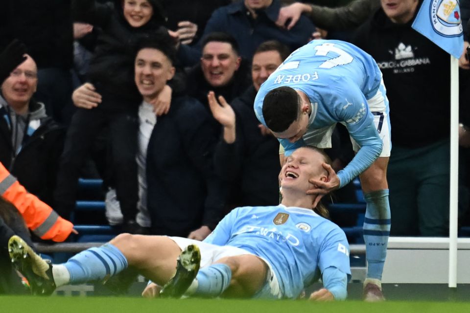 TOPSHOT - Manchester City's Norwegian striker #09 Erling Haaland (C) celebrates with Manchester City's English midfielder #47 Phil Foden (R) after scoring their third goal during the English Premier League football match between Manchester City and Manchester United at the Etihad Stadium in Manchester, north west England, on March 3, 2024. (Photo by Paul ELLIS / AFP) / RESTRICTED TO EDITORIAL USE. No use with unauthorized audio, video, data, fixture lists, club/league logos or 'live' services. Online in-match use limited to 120 images. An additional 40 images may be used in extra time. No video emulation. Social media in-match use limited to 120 images. An additional 40 images may be used in extra time. No use in betting publications, games or single club/league/player publications. /  (Photo by PAUL ELLIS/AFP via Getty Images)