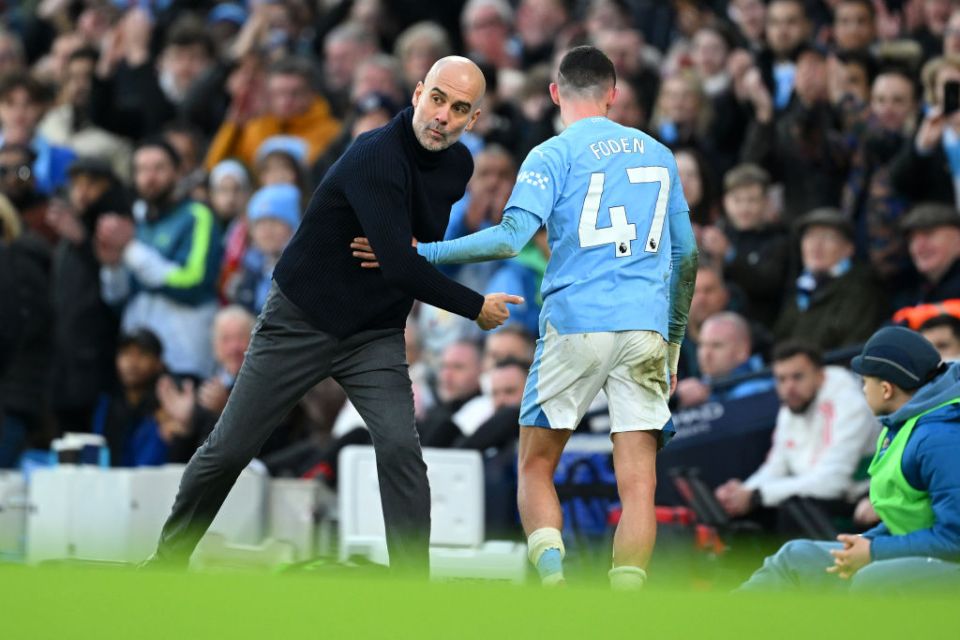 MANCHESTER, ENGLAND - MARCH 03: Phil Foden of Manchester City interacts with Pep Guardiola, Manager of Manchester City, after being substituted during the Premier League match between Manchester City and Manchester United at Etihad Stadium on March 03, 2024 in Manchester, England. (Photo by Michael Regan/Getty Images)