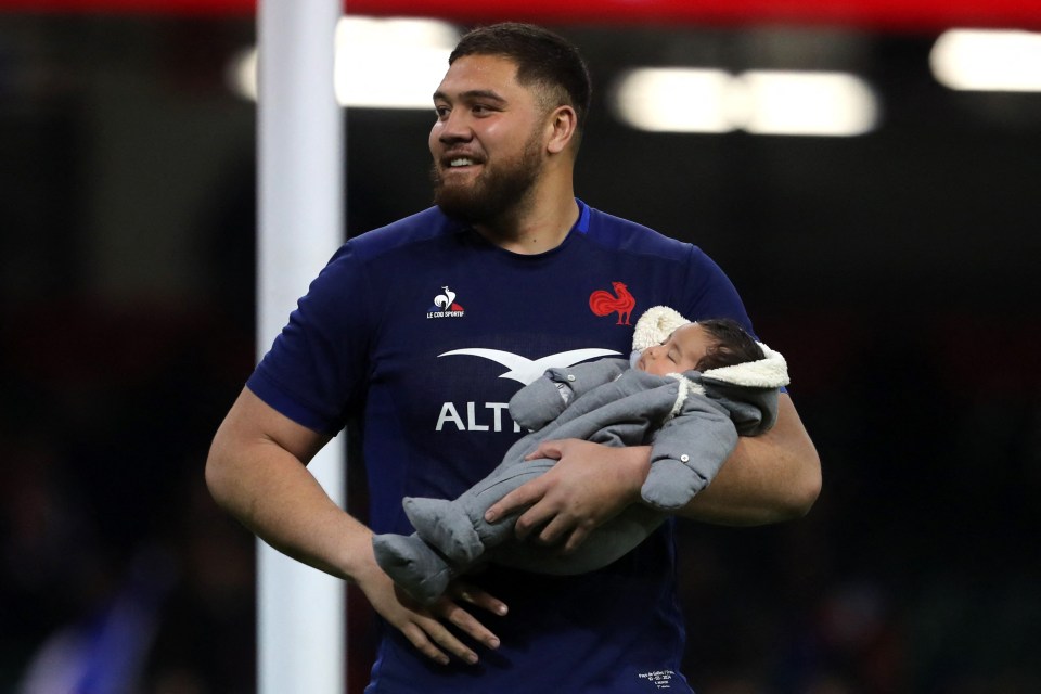 Emmanuel Meafou celebrates with his baby on the pitch