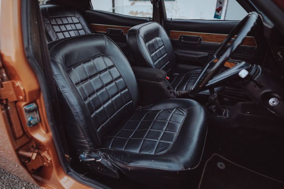 The interior is loaded with plush leather and light wood trim